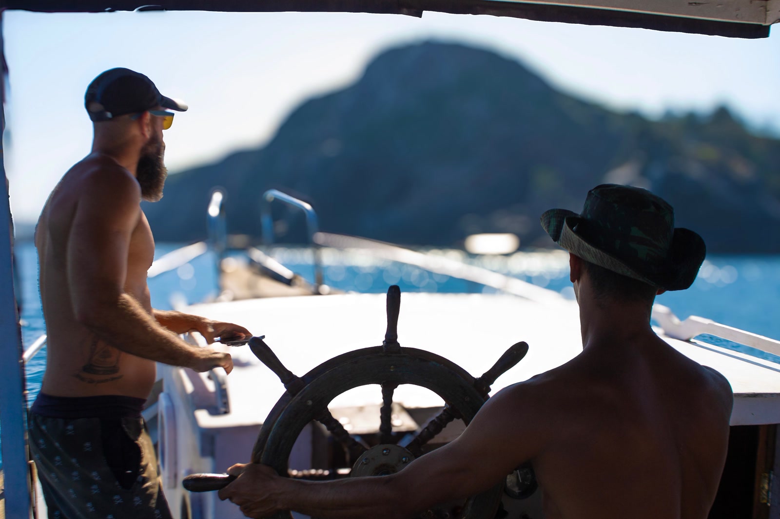 Boat crossing the calm morning water of Arraial do Cabo, a typical departure for the whale watching trip